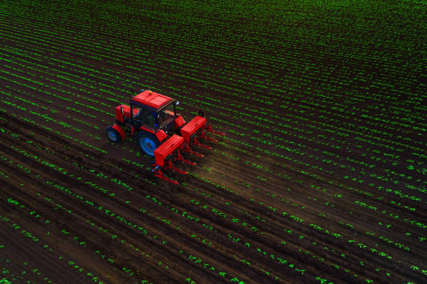 Tractor cultivating field at spring,aerial view